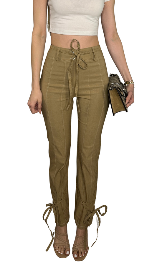 Khaki high-waisted tie pants with a removable belt, white contrast stitching, and tie accents at the ankles.