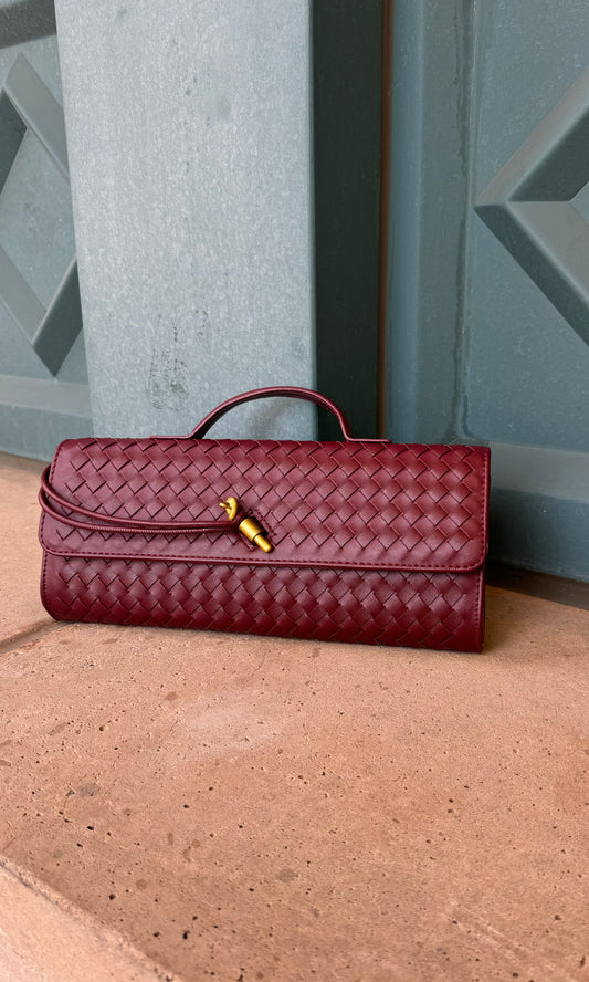 Maroon woven faux leather handbag with top handle and detachable shoulder strap