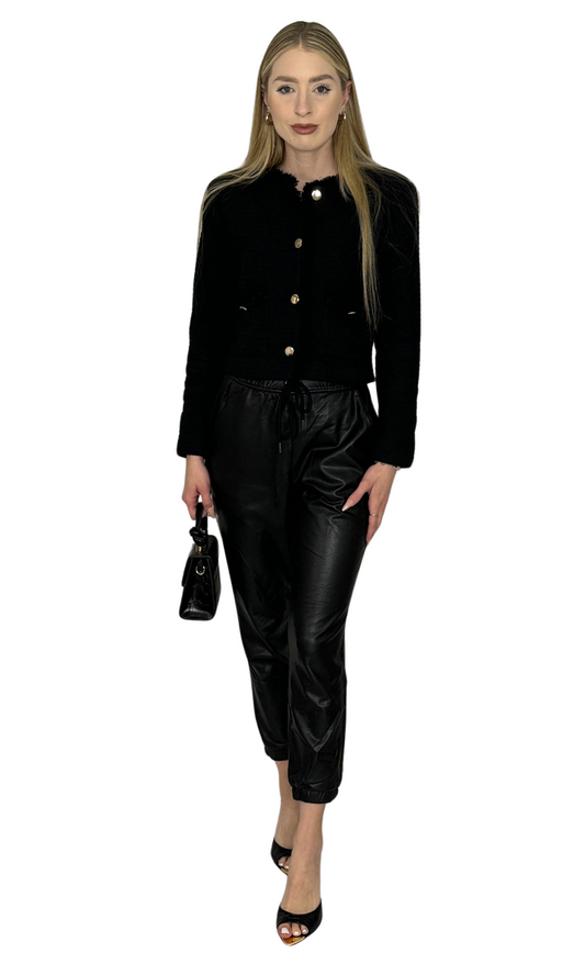 Women's black faux leather jogger pants with drawstring waist, gathered ankles, and front pockets – stylish and comfortable fit