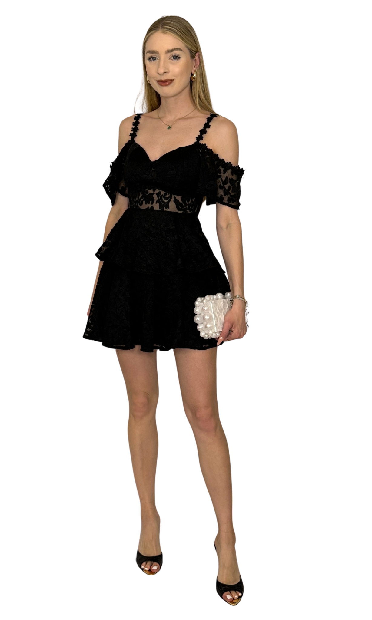 Black ruffle dress featuring open shoulders, a mesh front panel, intricate embroidery throughout the skirt and bodice layers, and a hidden back zipper, perfect for creating an unforgettable look on any occasion.