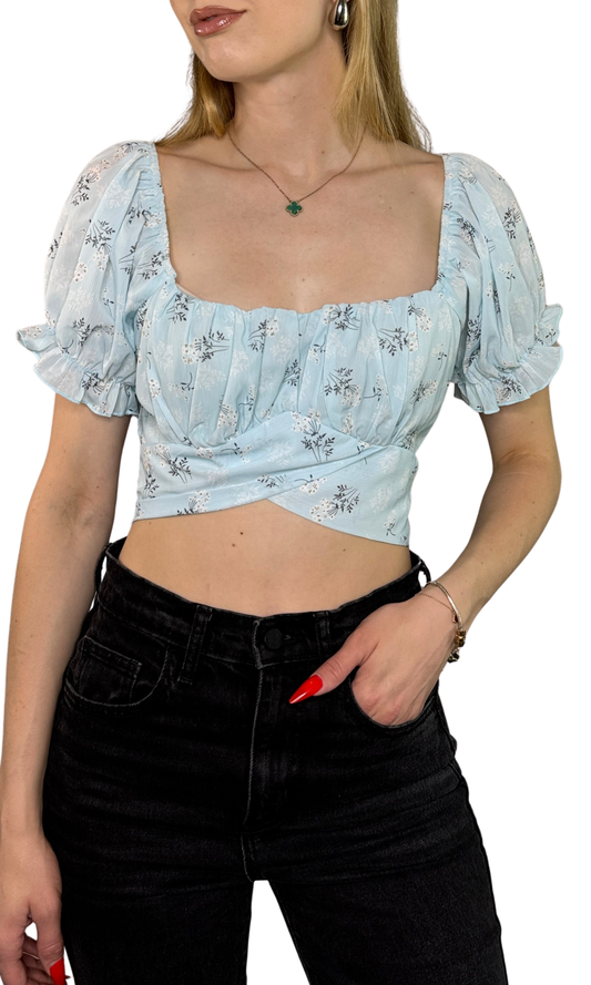 Blue and white floral print top with puff sleeves, tie-back straps, and a cut-out back detail, crafted from lightweight polyester for a flattering, breezy fit.