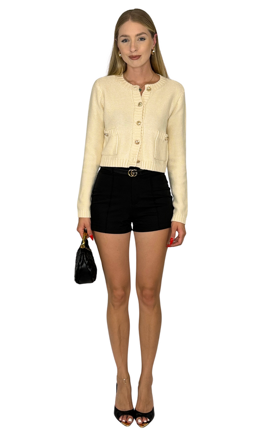 Cropped cardigan with round neckline, long sleeves, ribbed trim, and gold button details