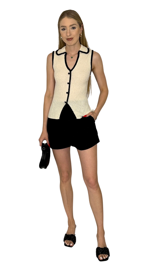 Knit sweater vest featuring a collared V-neckline, functional buttons, split hem, and contrast trim detail for a sophisticated and elegant look — the Odessa Knit Vest, perfect for layering or wearing solo.