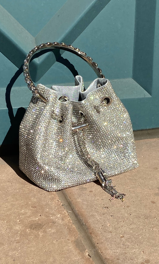 Elegant crystal bag with full rhinestone design, detachable chain strap, and hard crystal metal handle for a sparkling statement accessory.