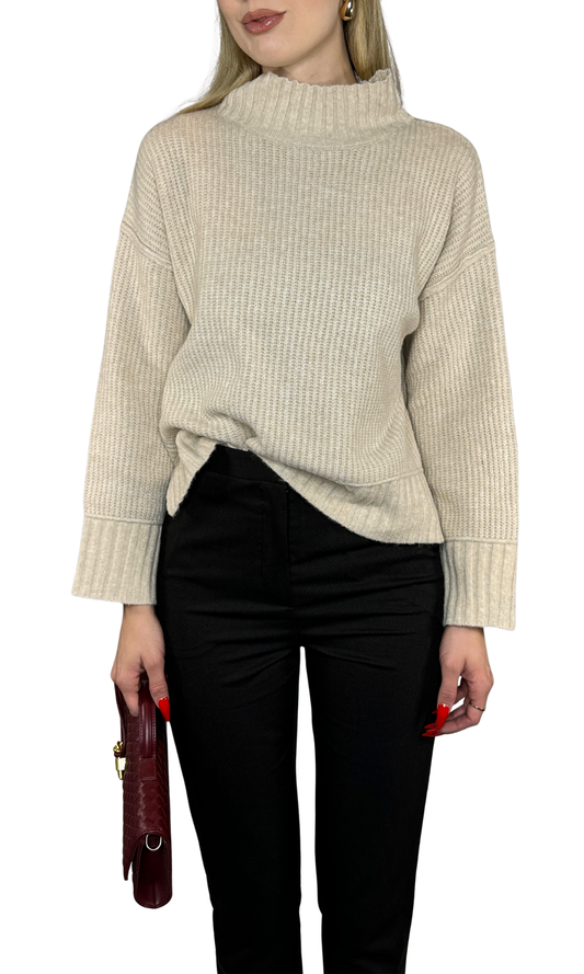 Ellora Sweater in warm beige, featuring soft rib knit fabric, a mock neck, long sleeves with extended cuffs, drop shoulder design, and split hem. A refined and versatile piece perfect for layering or standalone wear.