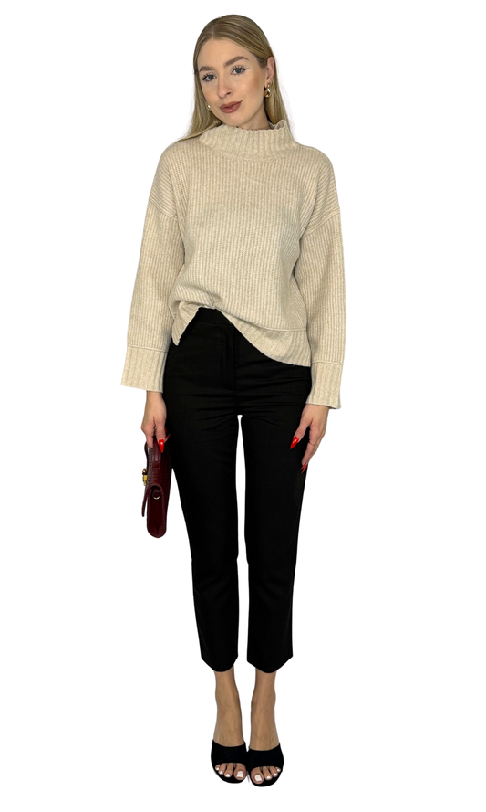Ellora Sweater in warm beige, featuring soft rib knit fabric, a mock neck, long sleeves with extended cuffs, drop shoulder design, and split hem. A refined and versatile piece perfect for layering or standalone wear.