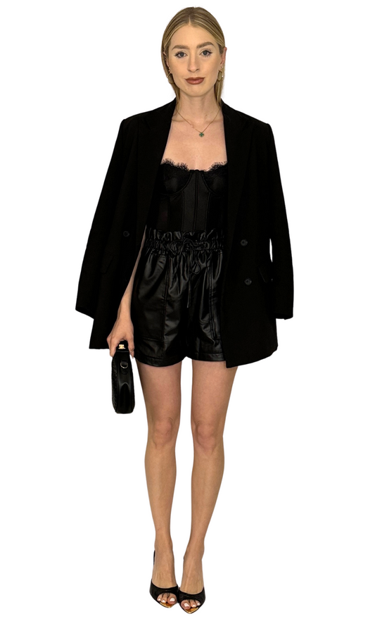 Women's faux leather shorts with elastic waistband, pockets, and cinched tie belt – stylish and adjustable fit