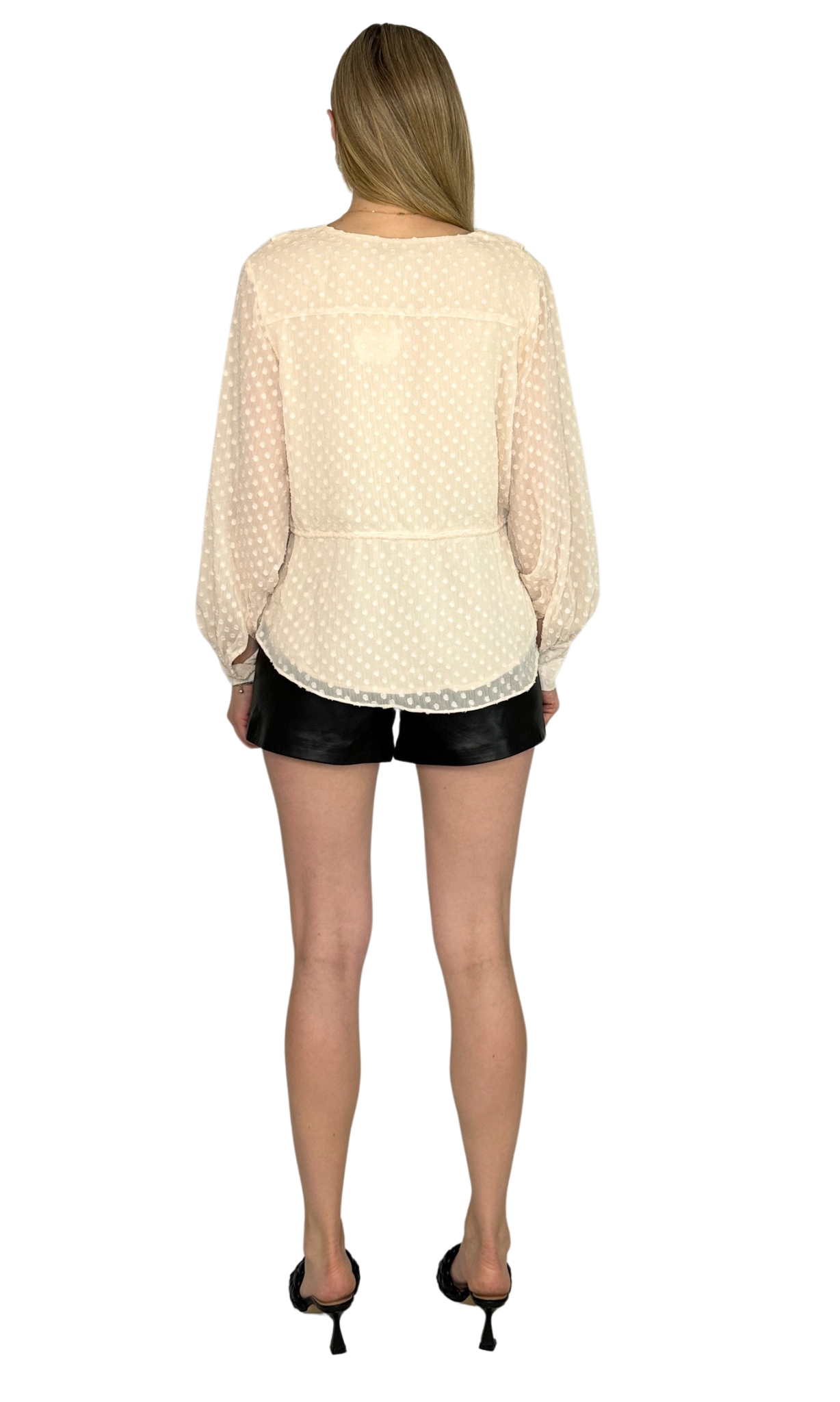 Ivory asymmetrical top featuring an adjustable drawstring waist tie and button tabbed cuffs, designed for a sophisticated look from day to night.