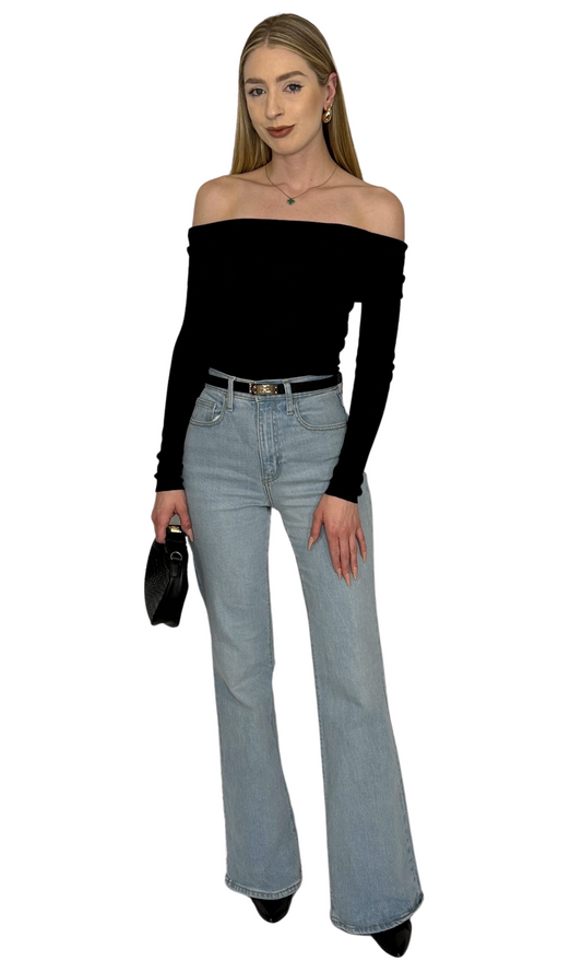Solid black off-the-shoulder sweater top featuring a fold over neckline and long fitted sleeves, crafted from soft sweater knit fabric for a luxurious and elegant look — the Vanessa Top.