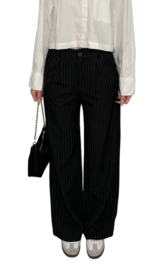 Women's black and white pinstriped trousers with elastic back, front pockets, and button closure – stylish and comfortable for professional wear