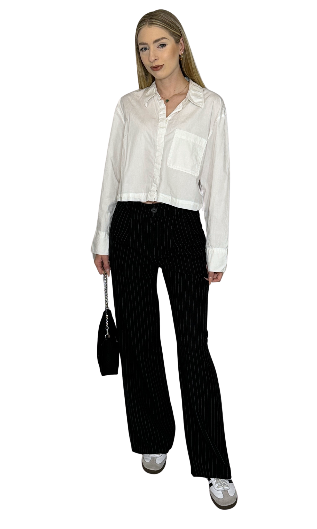 Women's black and white pinstriped trousers with elastic back, front pockets, and button closure – stylish and comfortable for professional wear