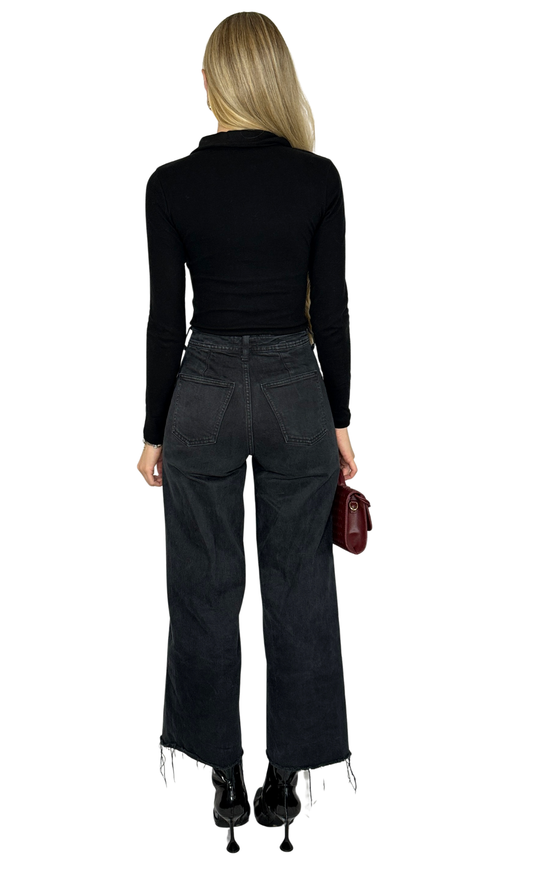 Sloan Bodysuit in black featuring a collared V-neckline, front button details, and long sleeves. Made from soft brushed fabric with a snap button closure for easy wear. A sleek, polished piece perfect for sophisticated, everyday looks.