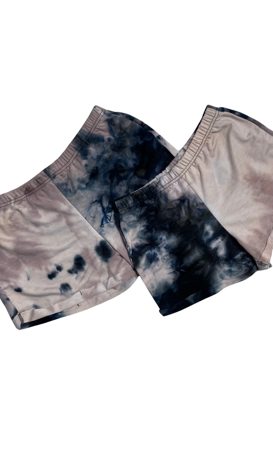 Pair of tie-dye shorts on a white background