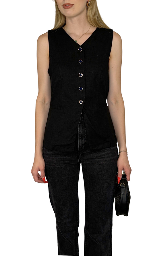 Sleeveless woven vest top featuring a flattering V-neckline, button down closure, non-functional pockets, split hem, and adjustable straps for a stylish and comfortable fit – the Delaney Vest.
