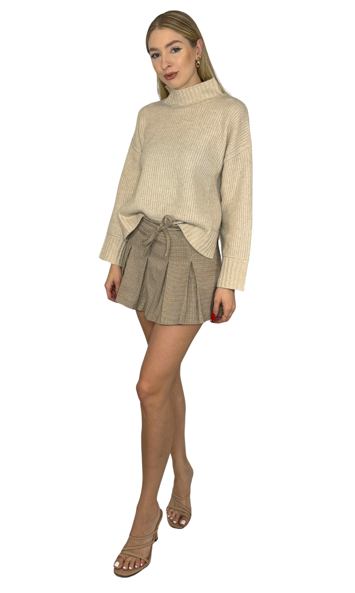 Vienna Mini Skirt in light taupe plaid featuring a high waist, delicate pleats, belt loop waist tie, side zipper, and built-in shorts. A sophisticated and versatile skirt perfect for both daytime and evening wear.