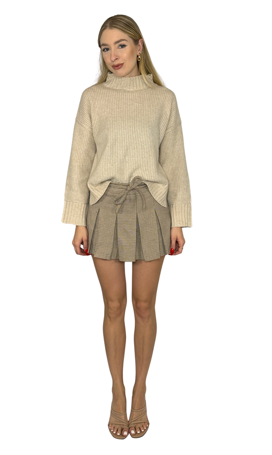 Vienna Mini Skirt in light taupe plaid featuring a high waist, delicate pleats, belt loop waist tie, side zipper, and built-in shorts. A sophisticated and versatile skirt perfect for both daytime and evening wear.