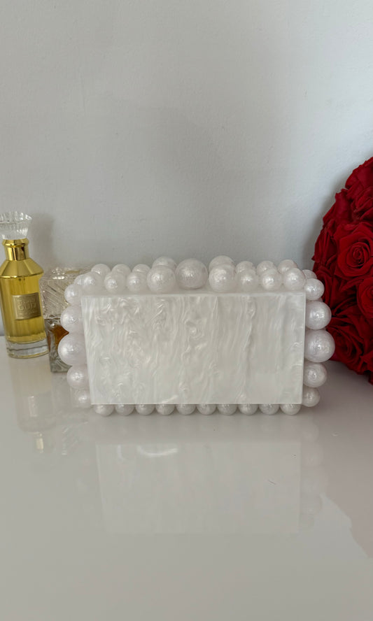 White acrylic beaded clutch bag with hard case design for elegant evening or casual looks.