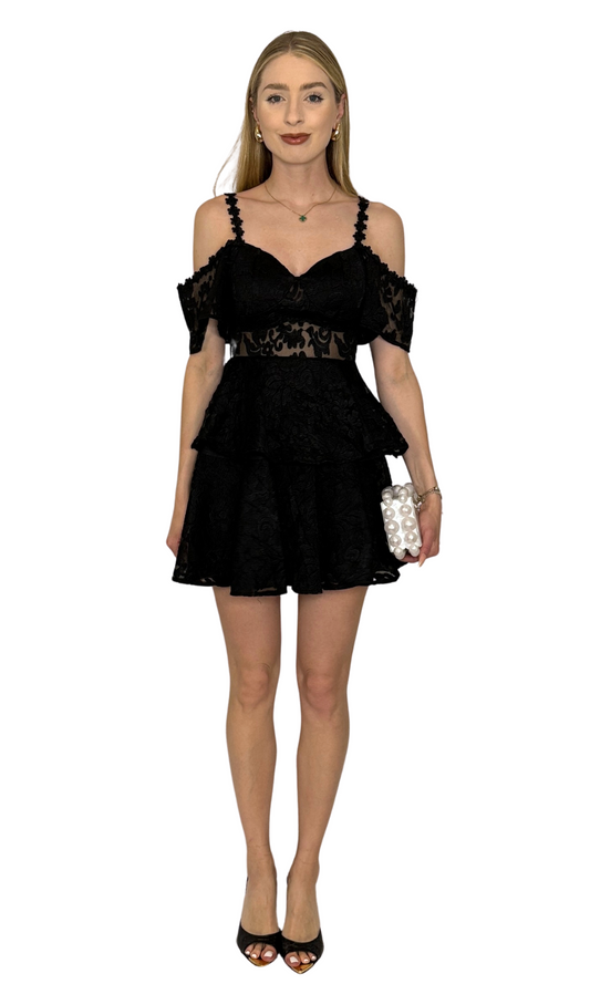 Black ruffle dress featuring open shoulders, a mesh front panel, intricate embroidery throughout the skirt and bodice layers, and a hidden back zipper, perfect for creating an unforgettable look on any occasion.