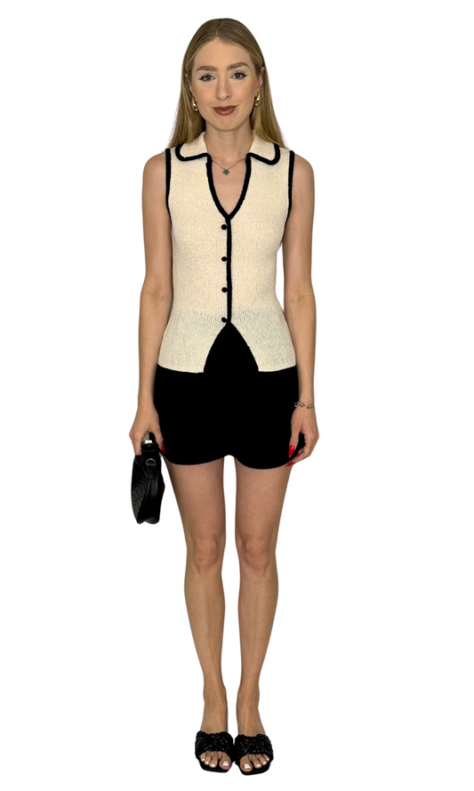 Knit sweater vest featuring a collared V-neckline, functional buttons, split hem, and contrast trim detail for a sophisticated and elegant look — the Odessa Knit Vest, perfect for layering or wearing solo.