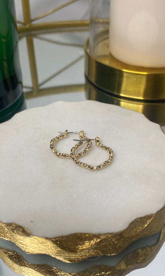 Gold-plated hand-hammered thin hoop earrings with textured finish, perfect for a sophisticated day-to-night look.