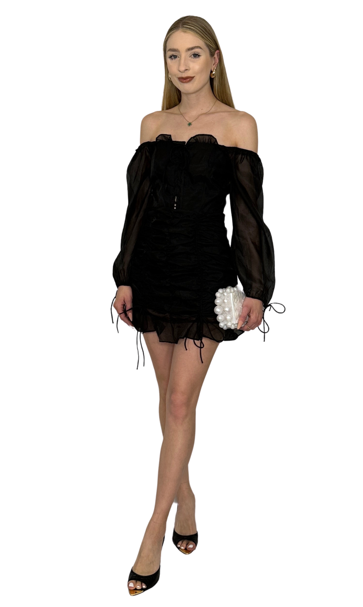 Off-the-shoulder black organza semi-sheer dress featuring lace-up front detail, ruched skirt with ties, balloon sleeves with ruffle and ties, and center back zipper, perfect for a timeless romantic look.