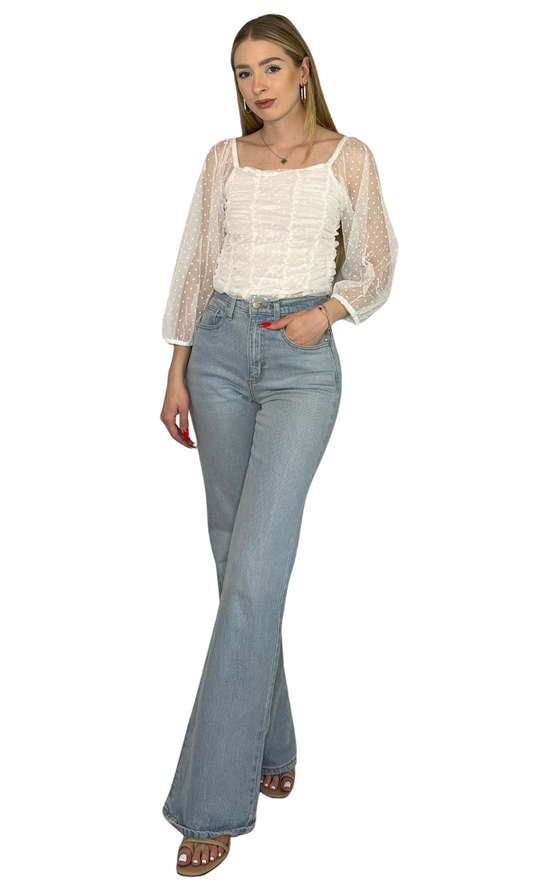 Semi-sheer top with velvet dot pattern, 3/4 sleeves, and flattering ruching on the front and back, offering elegant style and lightweight comfort for day or night.