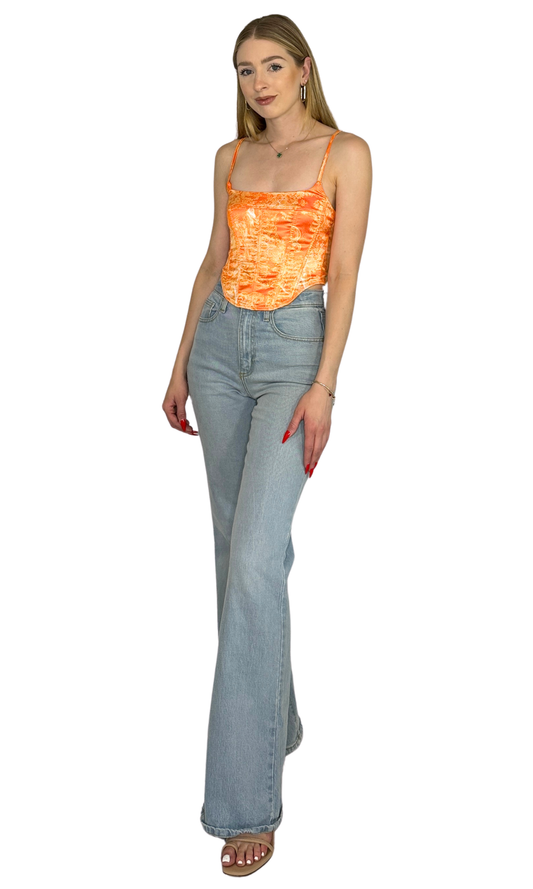 White and orange printed corset top crafted from lightweight fabric, featuring structured boning and a lace-up back for a flattering, statement-making fit.
